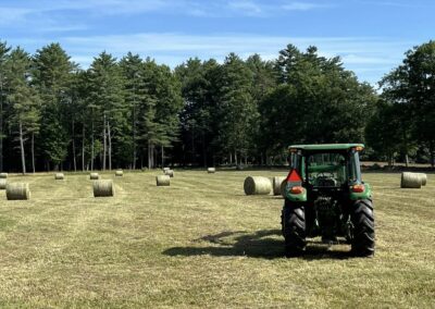 Lush pastures and hay storage area at Rockwall Acres Farm during harvest season